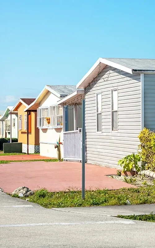 A row of houses on the side of a street.