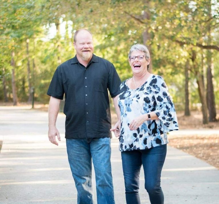 A man and woman walking down the street