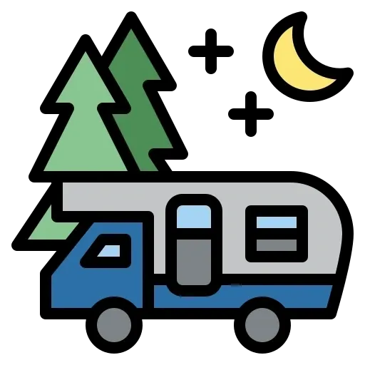 A blue and white rv with trees in the background