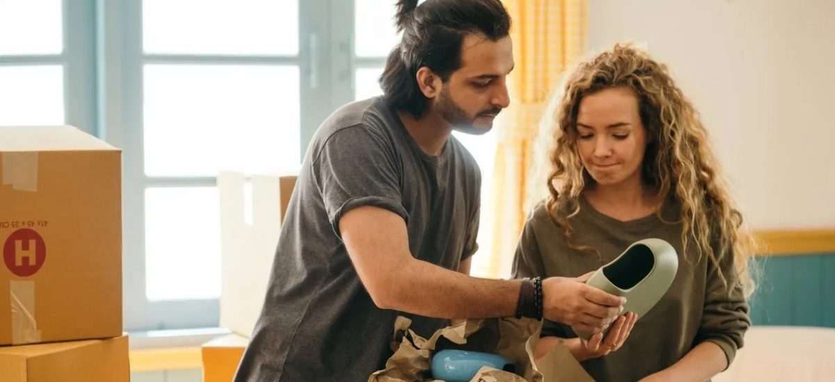 A man and woman looking at a phone.