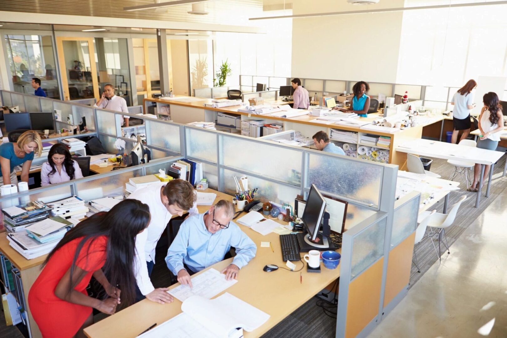 A group of people sitting at desks in an office.