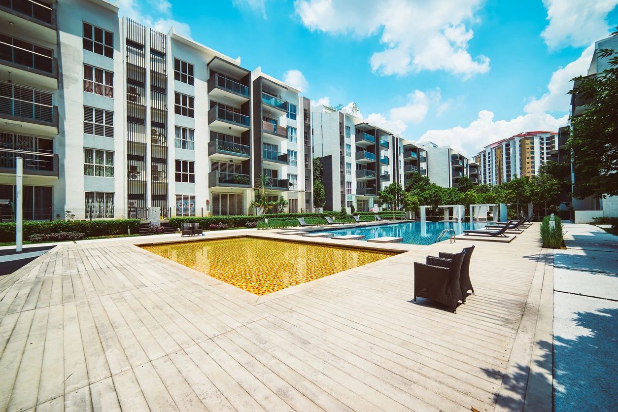 A large swimming pool with many buildings in the background.