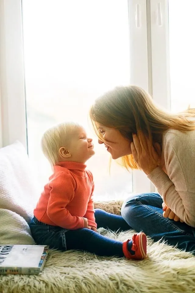 A woman and child are sitting on the floor